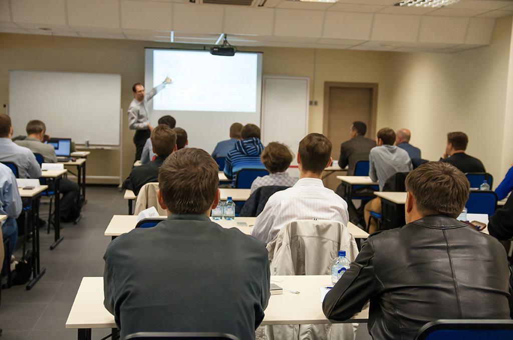 Group of student in a classroom looking at a teacher.